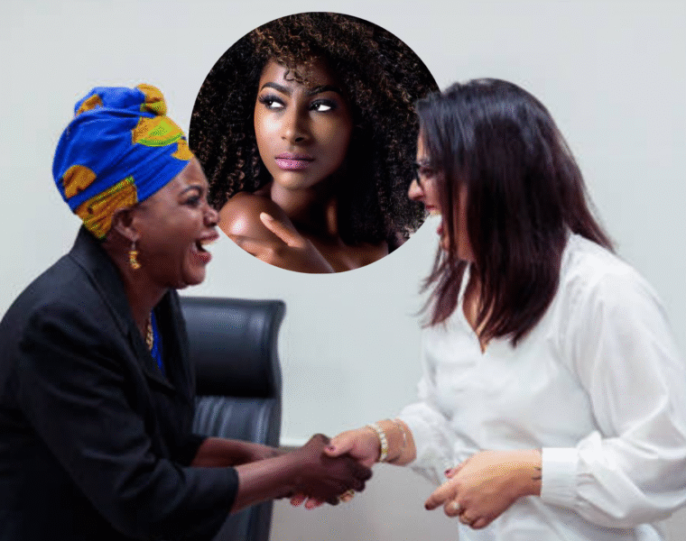African woman shaking hands with a Indian woman.