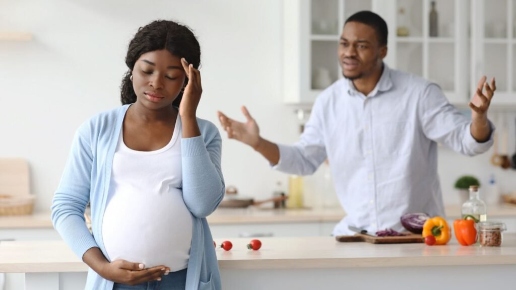 Pregnant woman and man arguing in the house