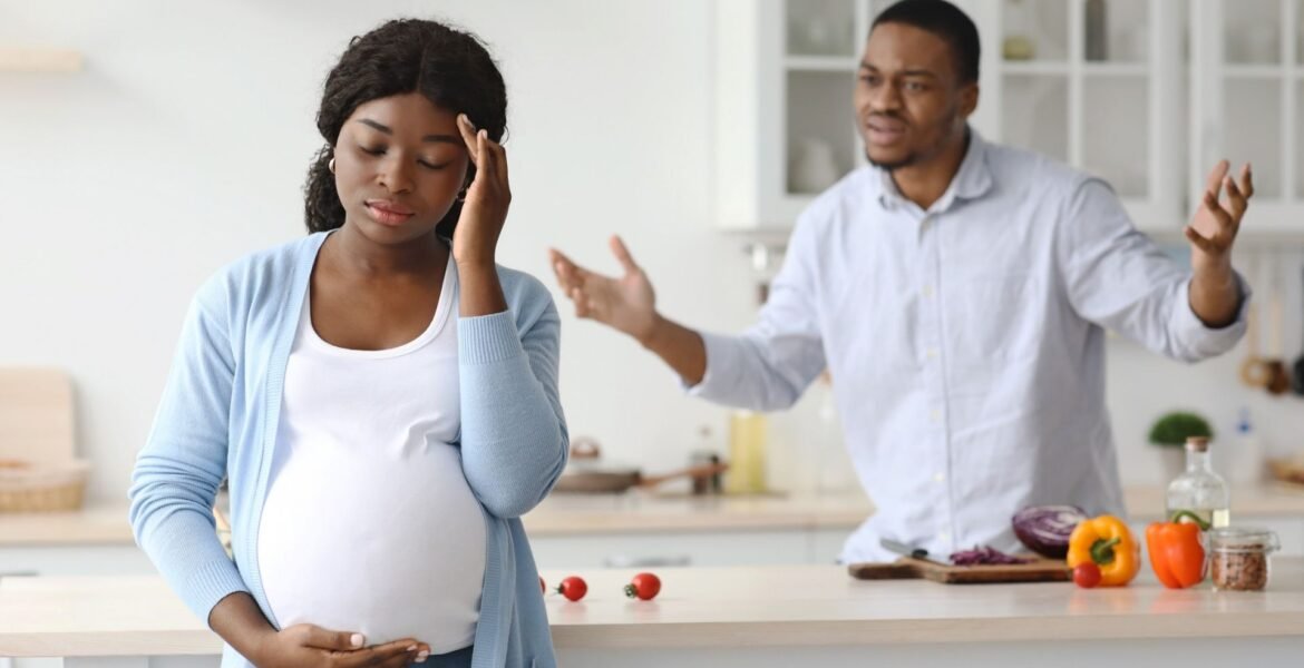 Pregnant woman and man arguing in the house
